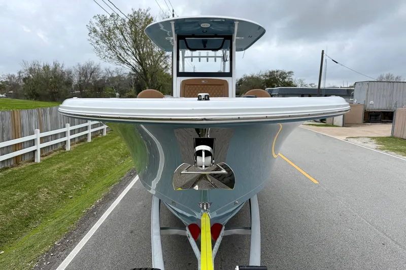 Slide: The Image of 2026 Sea Hunt Ultra 285 SE boat on trailer, parked on a road. - 6