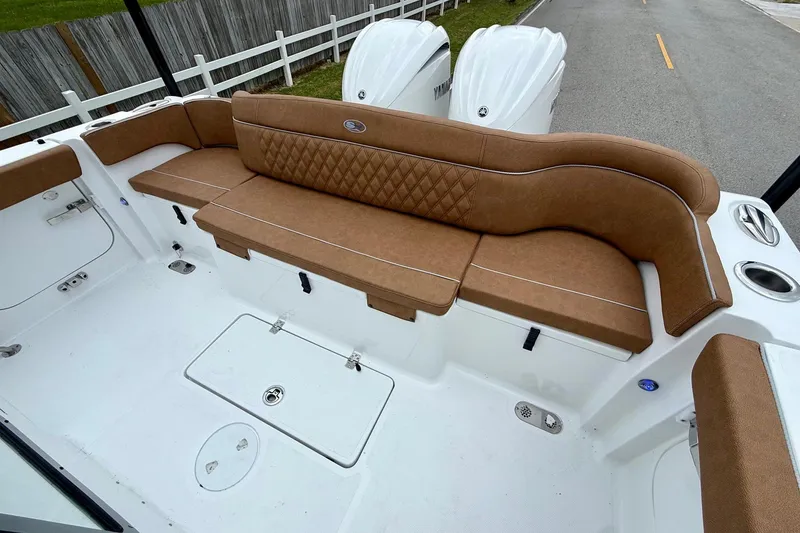 Slide: The Image of 2026 Sea Hunt Ultra 285 SE boat with brown cushioned seating and white deck. - 7