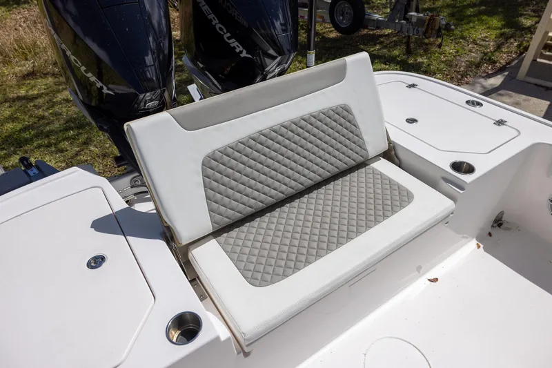 Slide: The Image of 2022 Caymas 28 HB Twin boat with cushioned seating and dual Mercury engines. - 12