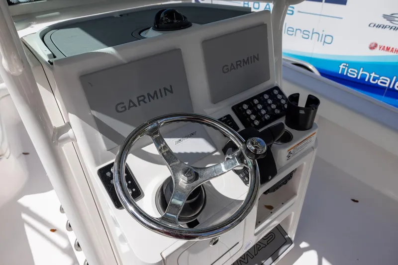 Slide: The Image of Steering console of 2022 Caymas 28 HB Twin with Garmin displays and controls. - 13
