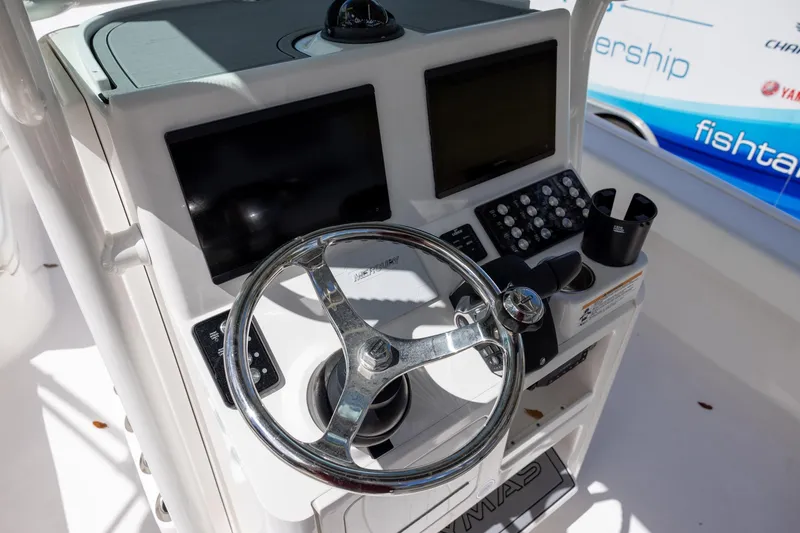 Slide: The Image of 2022 Caymas 28 HB Twin boat helm with steering wheel and control panel. - 14