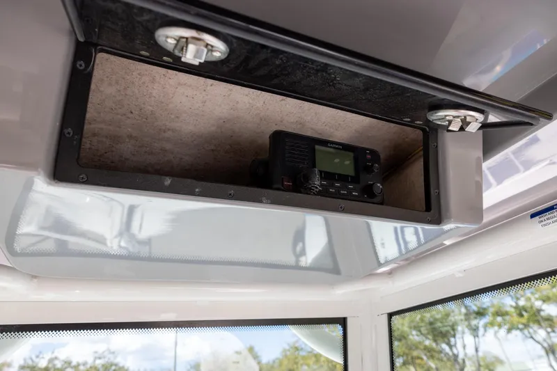 Slide: The Image of 2022 Caymas 28 HB Twin boat with Garmin radio in overhead compartment. - 15