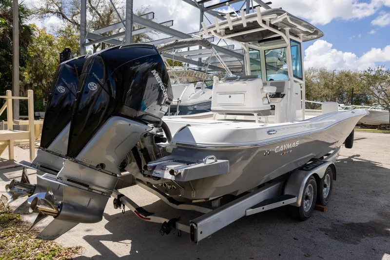 Slide: The Image of 2022 Caymas 28 HB Twin boat with dual Mercury engines on a trailer. - 4