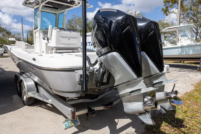 Slide: The Image of 2022 Caymas 28 HB Twin boat with dual outboard engines on a trailer. - 5