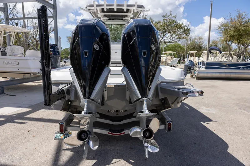 Slide: The Image of 2022 Caymas 28 HB Twin boat with dual outboard engines, parked outdoors. - 6