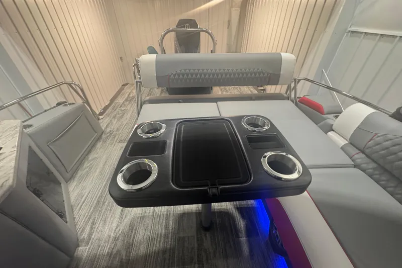 Slide: The Image of 2025 Avalon Catalina Cruise boat interior with rear bench, table, and cup holders. - 11