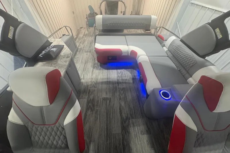 Slide: The Image of 2025 Avalon Catalina Cruise boat interior with red and gray seating, blue LED lighting. - 16