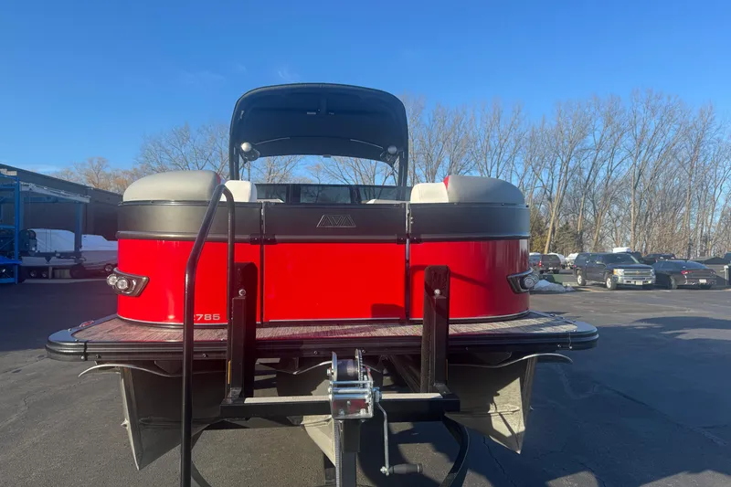 Slide: The Image of 2025 Avalon Catalina Cruise Rear Bench Windshield pontoon boat, red exterior, parked outdoors. - 2