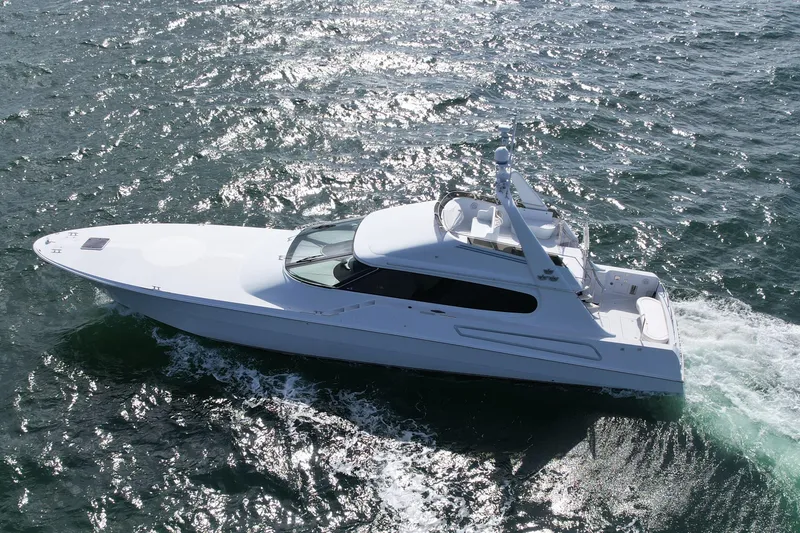 The Image of 1987 Magnum 70 Convertible yacht cruising on open water. - 0