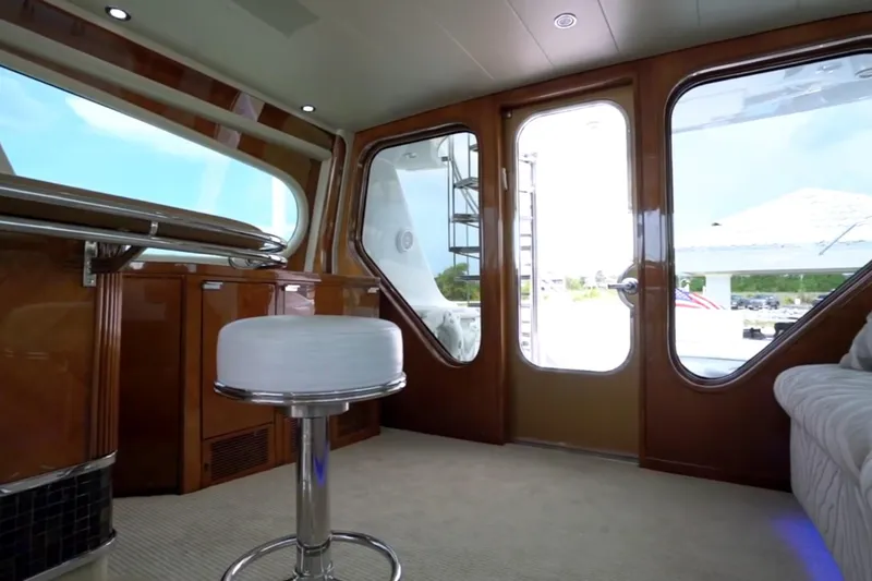 Slide: The Image of Interior of 1987 Magnum 70 Convertible yacht with modern seating and wooden finishes. - 10