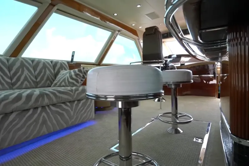 Slide: The Image of Luxurious interior of a 1987 Magnum 70 Convertible yacht with modern seating and zebra-patterned sofa. - 11