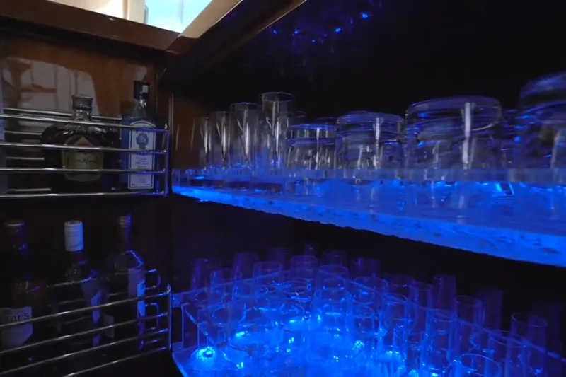 Slide: The Image of Bar area in 1987 Magnum 70 Convertible with illuminated glassware and liquor bottles. - 12