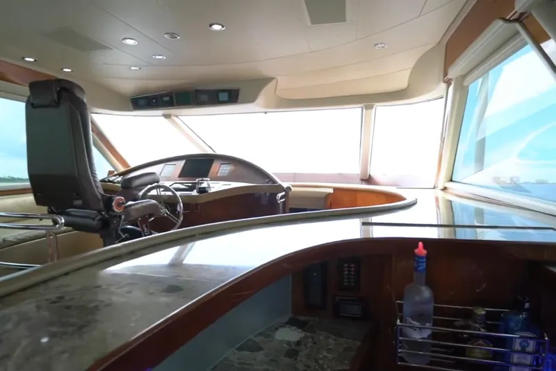 Slide: The Image of Luxurious interior of a 1987 Magnum 70 Convertible yacht with modern helm and bar area. - 13