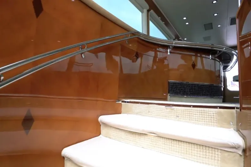 Slide: The Image of Interior staircase of 1987 Magnum 70 Convertible yacht with polished wood and metal railings. - 16