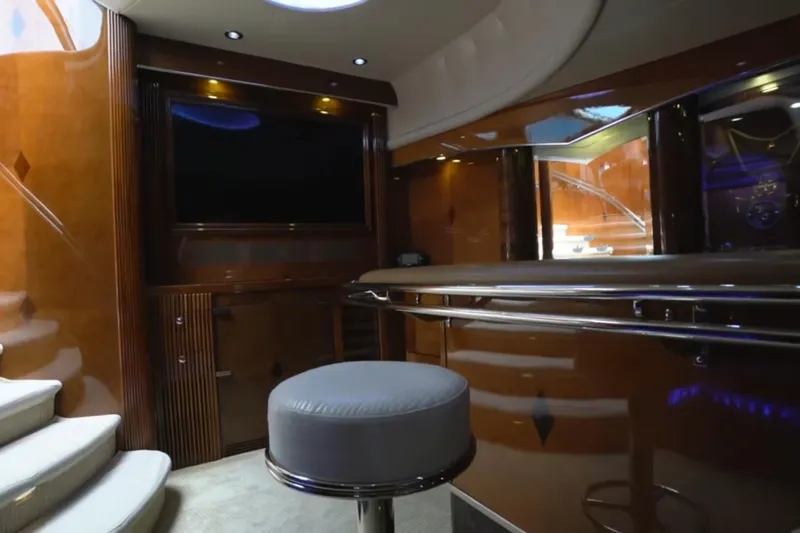Slide: The Image of Luxurious interior of a 1987 Magnum 70 Convertible yacht with elegant wood finishes. - 18