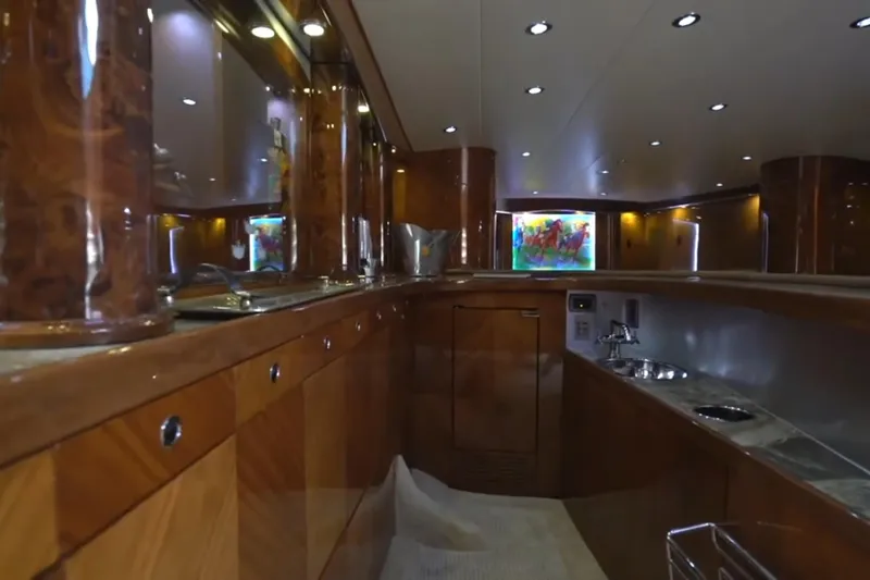 Slide: The Image of Luxurious interior of a 1987 Magnum 70 Convertible yacht with polished wood finishes. - 19