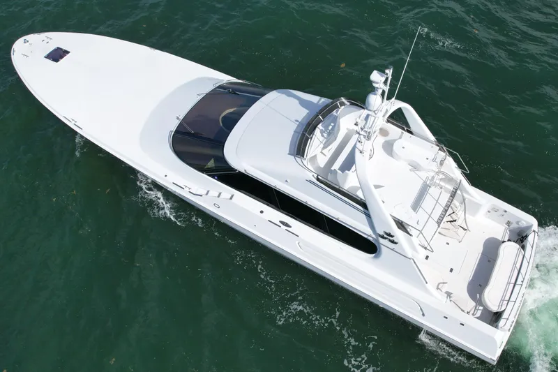 Slide: The Image of 1987 Magnum 70 Convertible yacht cruising on open water, aerial view. - 2