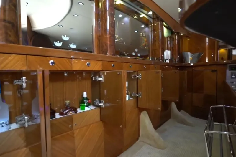Slide: The Image of Luxurious wooden interior of a 1987 Magnum 70 Convertible yacht with mirrored cabinets. - 20