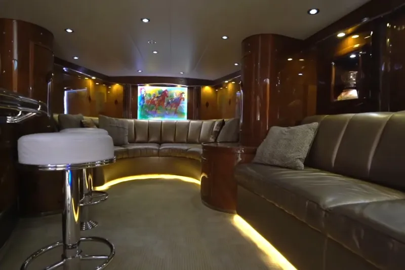 Slide: The Image of Luxurious interior of a 1987 Magnum 70 Convertible yacht with plush seating and ambient lighting. - 22