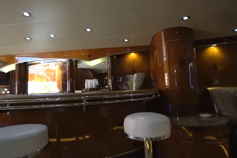 Slide: The Image of Luxurious interior of a 1987 Magnum 70 Convertible yacht with elegant bar and seating area. - 24