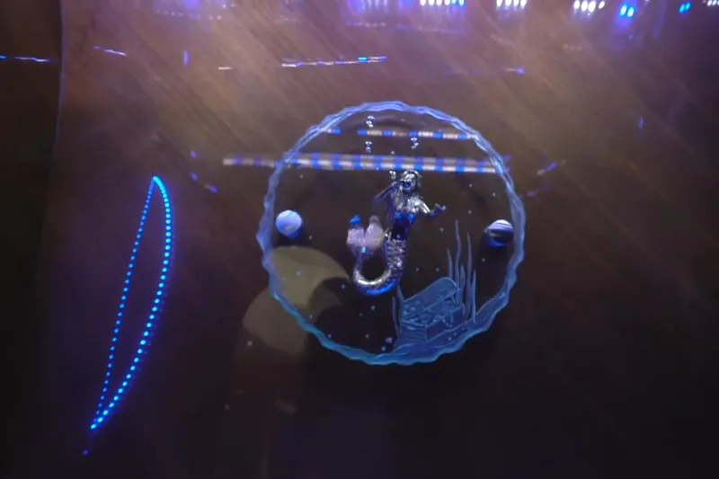 Slide: The Image of Illuminated mermaid figurine in glass dish, surrounded by blue LED lights. - 28