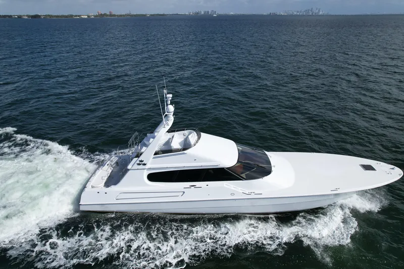 Slide: The Image of 1987 Magnum 70 Convertible yacht cruising on open water. - 33