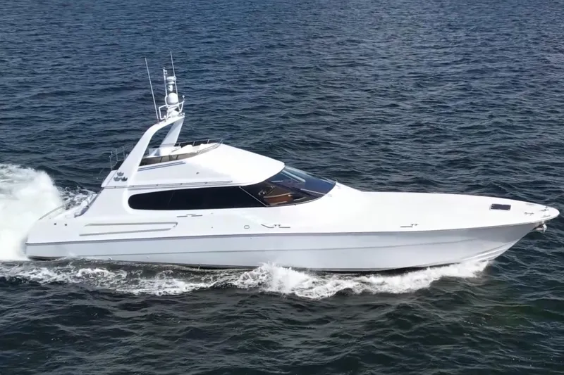 Slide: The Image of 1987 Magnum 70 Convertible yacht cruising on open water. - 34