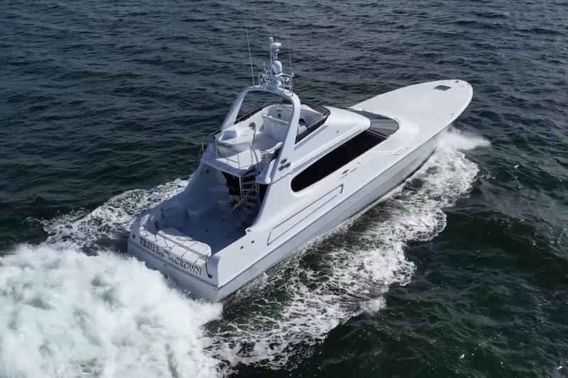 Slide: The Image of 1987 Magnum 70 Convertible yacht cruising on open water, aerial view. - 35