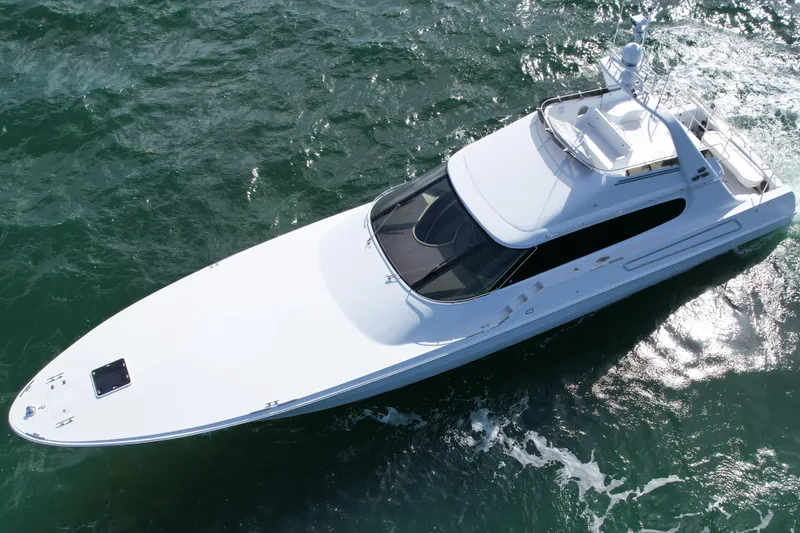 Slide: The Image of 1987 Magnum 70 Convertible yacht cruising on open water, aerial view. - 36