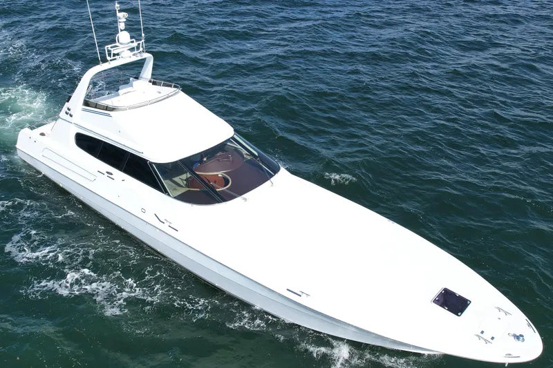 Slide: The Image of 1987 Magnum 70 Convertible yacht cruising on open water. - 37