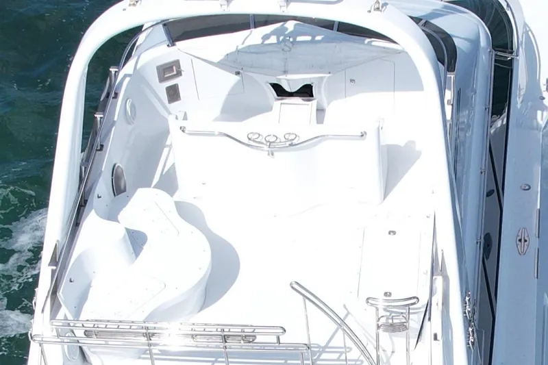 Slide: The Image of 1987 Magnum 70 Convertible yacht, white deck, sleek design, cruising on water. - 6