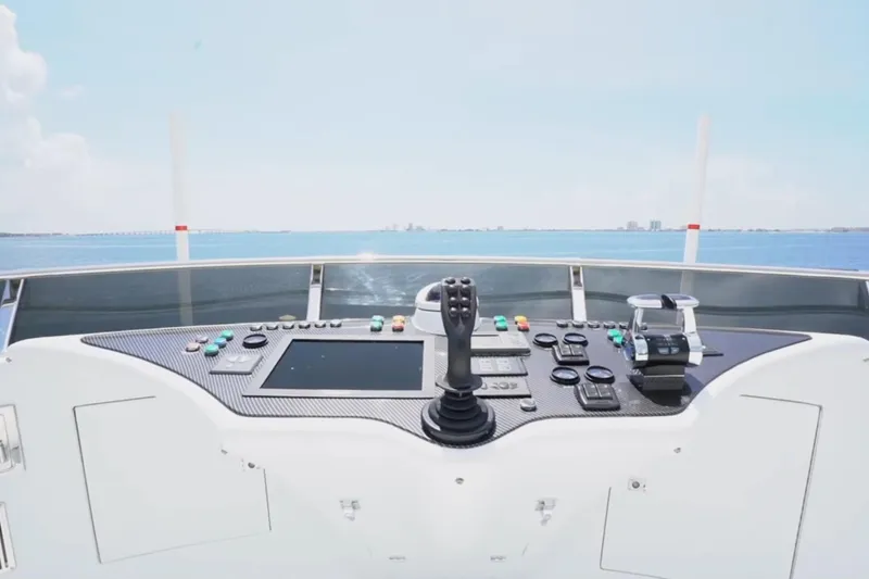 Slide: The Image of Control panel of 1987 Magnum 70 Convertible yacht with ocean view. - 7