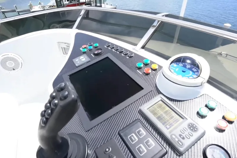 Slide: The Image of Control panel of a 1987 Magnum 70 Convertible yacht with joystick and gauges. - 8