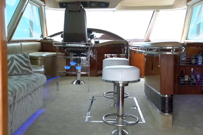 Slide: The Image of Luxurious interior of a 1987 Magnum 70 Convertible yacht with modern seating and bar area. - 9