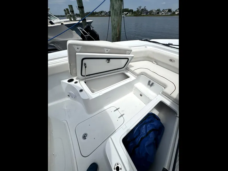 Slide: The Image of 2022 Sea Hunt Ultra 275 SE boat interior with open storage compartments. - 11