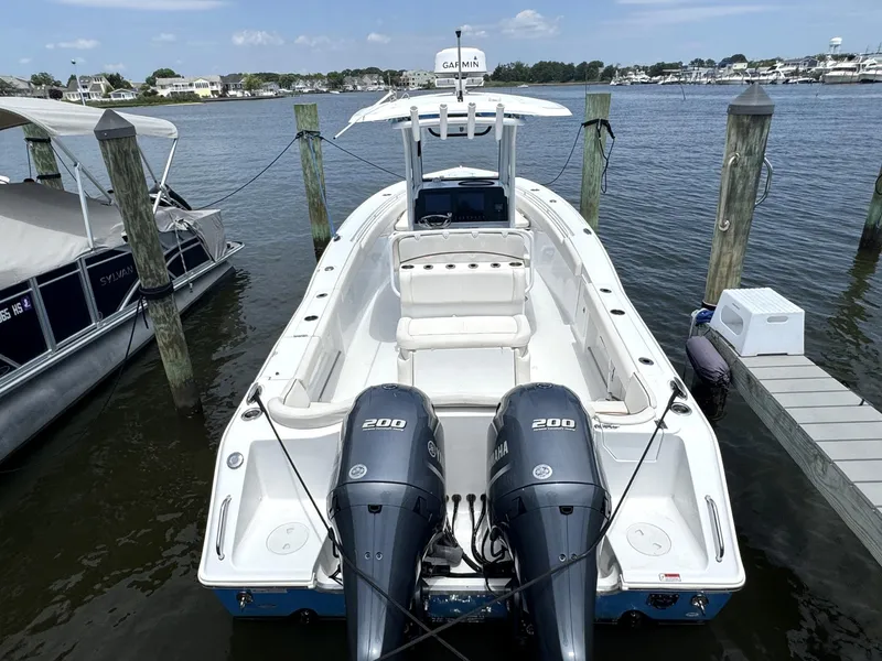 Slide: The Image of 2022 Sea Hunt Ultra 275 SE boat docked with twin 200 engines. - 14