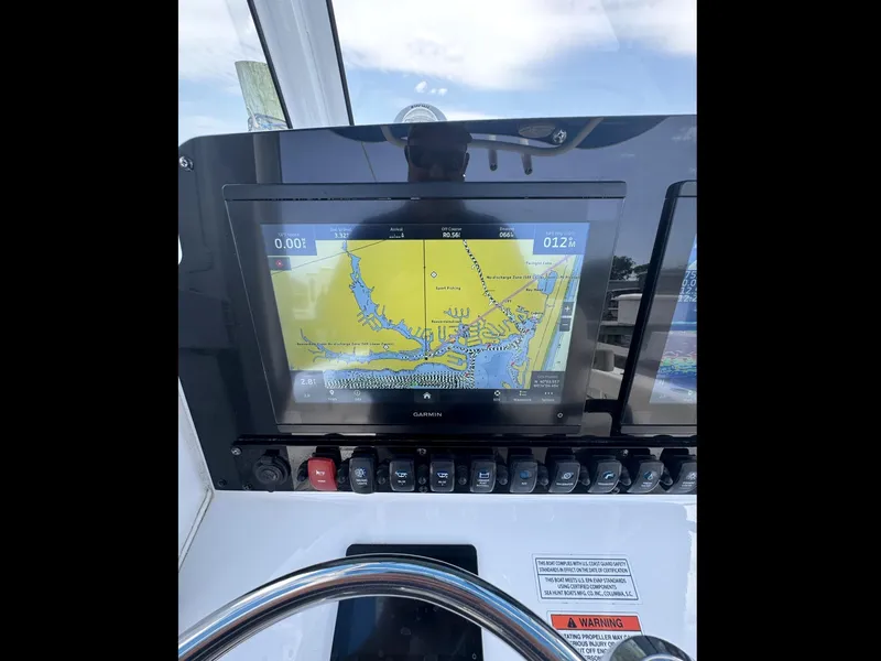 Slide: The Image of Dashboard of 2022 Sea Hunt Ultra 275 SE with Garmin navigation display. - 18