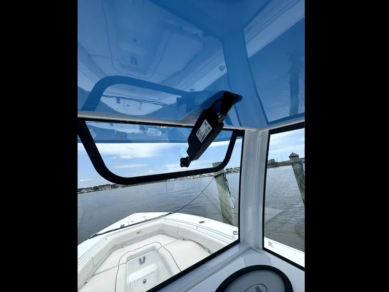 Slide: The Image of 2022 Sea Hunt Ultra 275 SE boat interior with blue canopy and water view. - 28