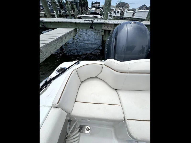 Slide: The Image of 2022 Sea Hunt Ultra 275 SE boat with white seating at a dock. - 36