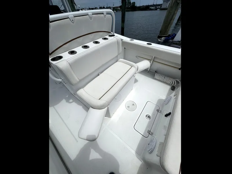 Slide: The Image of 2022 Sea Hunt Ultra 275 SE boat interior with white seating and cup holders. - 4