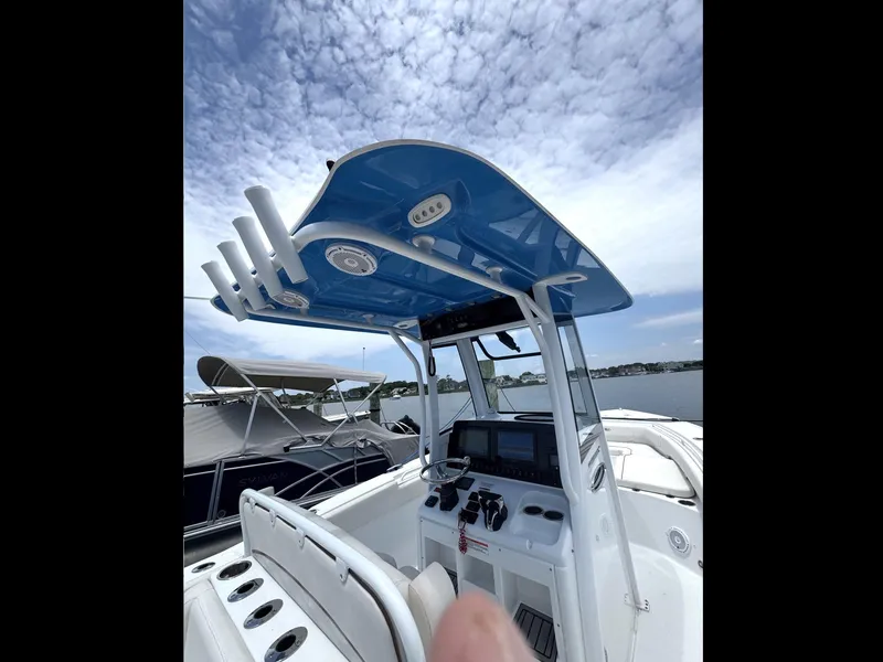 Slide: The Image of 2022 Sea Hunt Ultra 275 SE boat interior with blue T-top and control panel. - 42