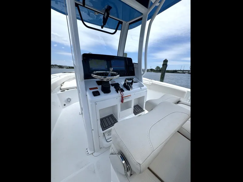 Slide: The Image of 2022 Sea Hunt Ultra 275 SE boat cockpit with steering wheel and navigation system. - 49