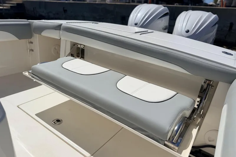 Slide: The Image of 2022 Regulator 28 boat with foldable seating and dual outboard engines. - 13