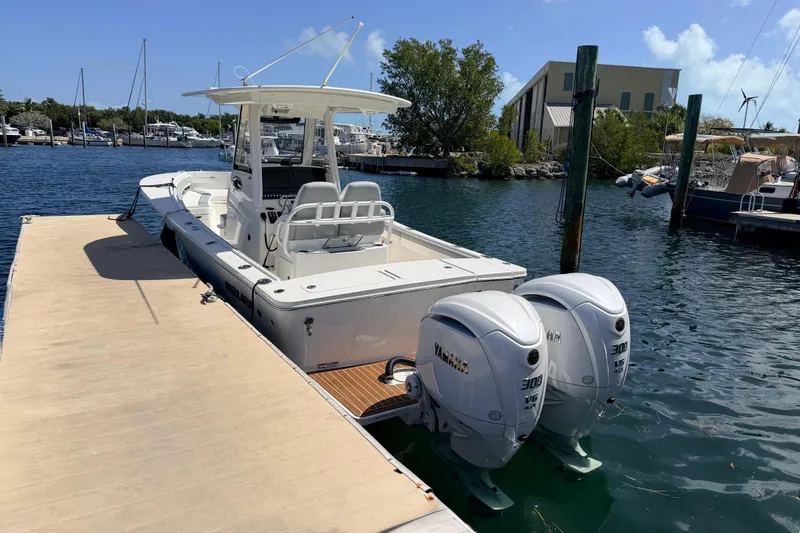 Slide: The Image of 2022 Regulator 28 boat docked with twin Yamaha 300 engines. - 2