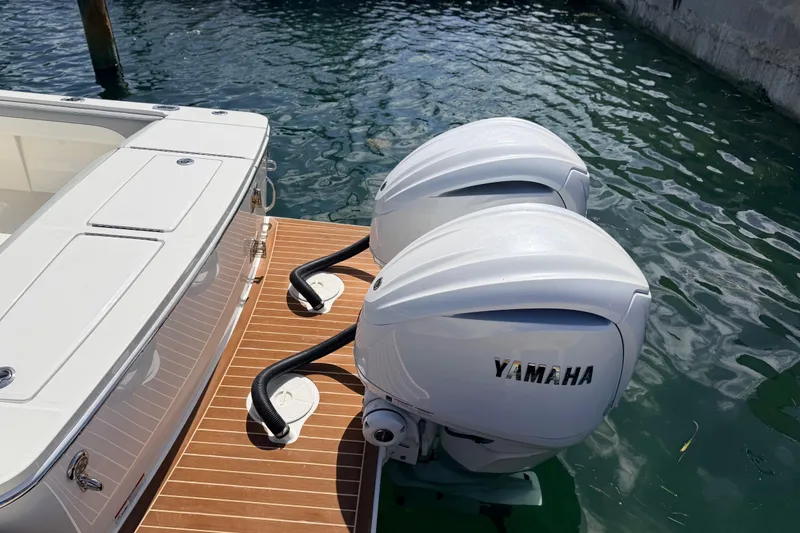 Slide: The Image of 2022 Regulator 28 boat with twin Yamaha outboard engines on water. - 4