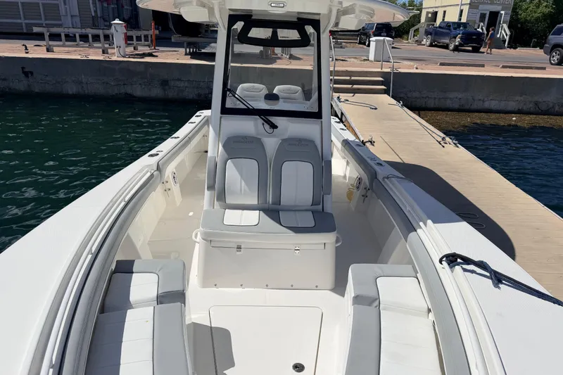 Slide: The Image of 2022 Regulator 28 boat docked, showcasing spacious seating and sleek design. - 5