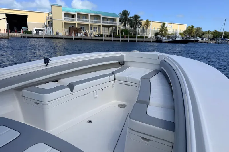 Slide: The Image of 2022 Regulator 28 boat interior with cushioned seating, dockside view. - 7