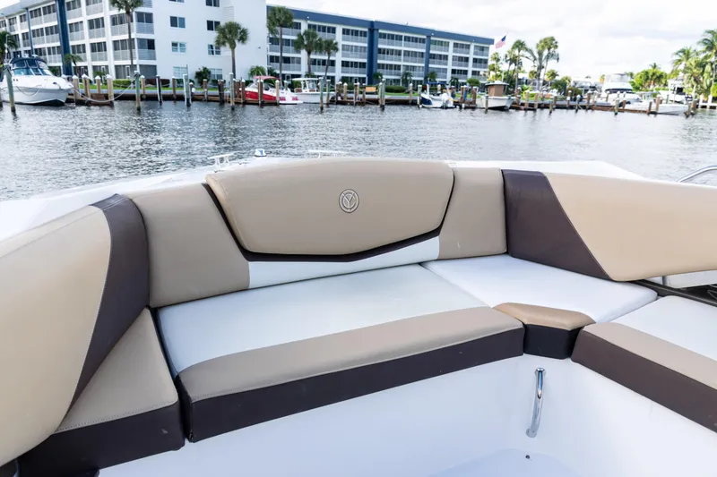 Slide: The Image of 2015 Cruisers Yachts 338 Bow Rider interior seating with beige and white upholstery. - 11