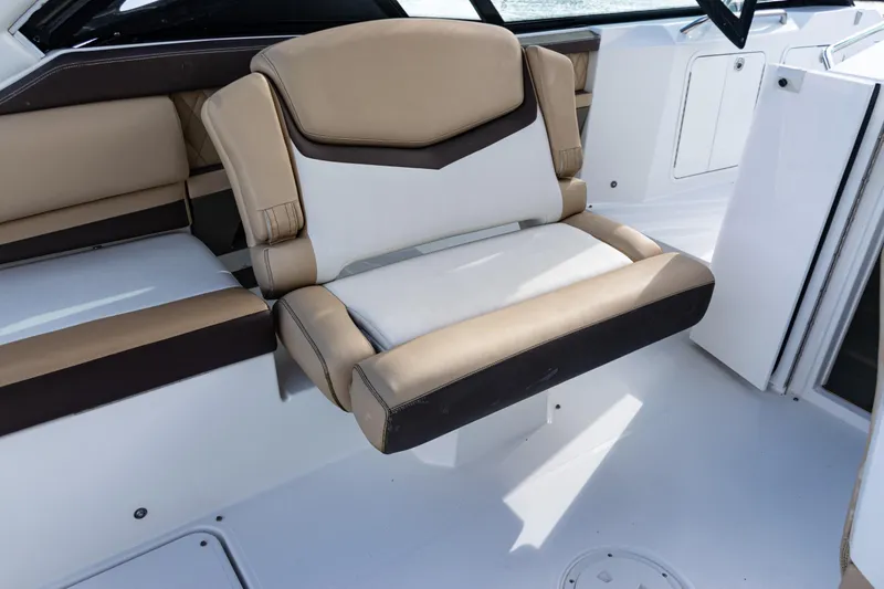 Slide: The Image of 2015 Cruisers Yachts 338 Bow Rider interior with seating and control panel. - 18
