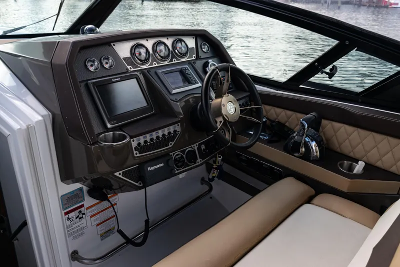 Slide: The Image of 2015 Cruisers Yachts 338 Bow Rider helm with modern controls and luxurious seating. - 22